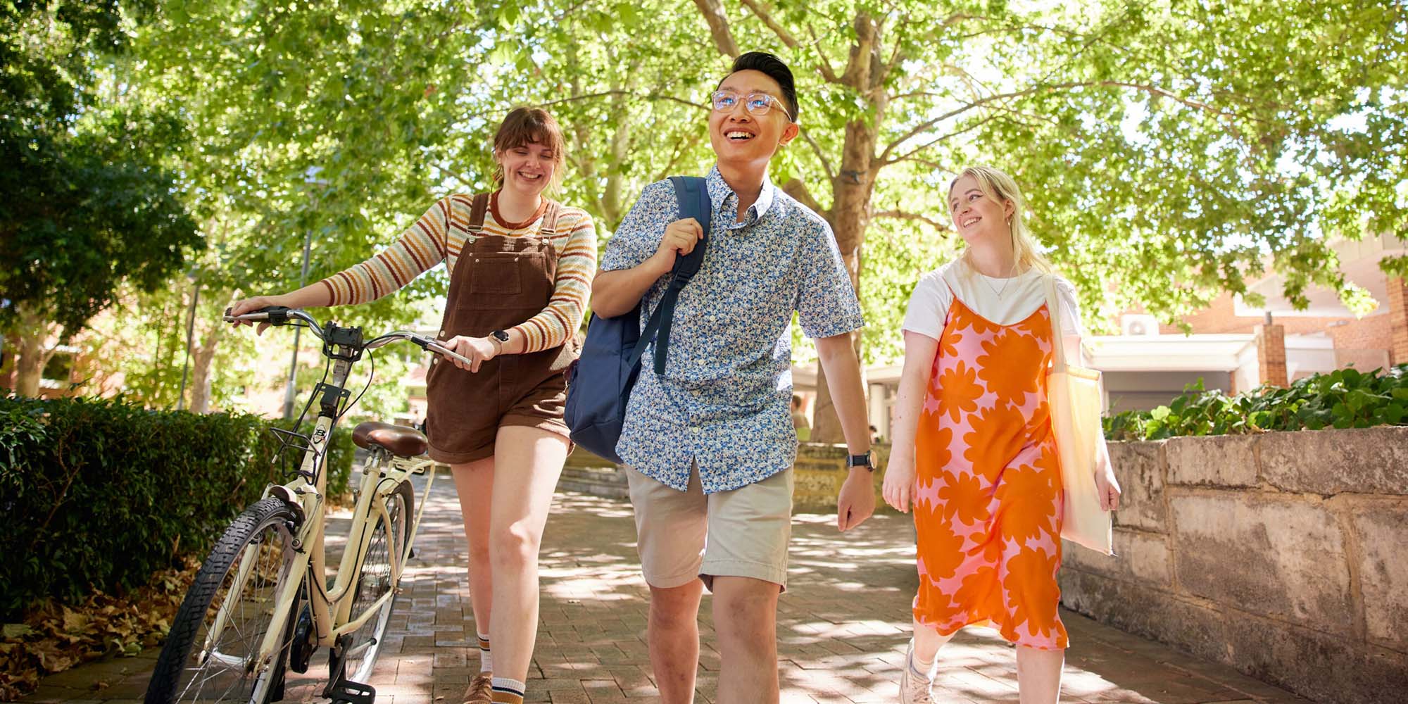 Three students walking around the Curtin campus