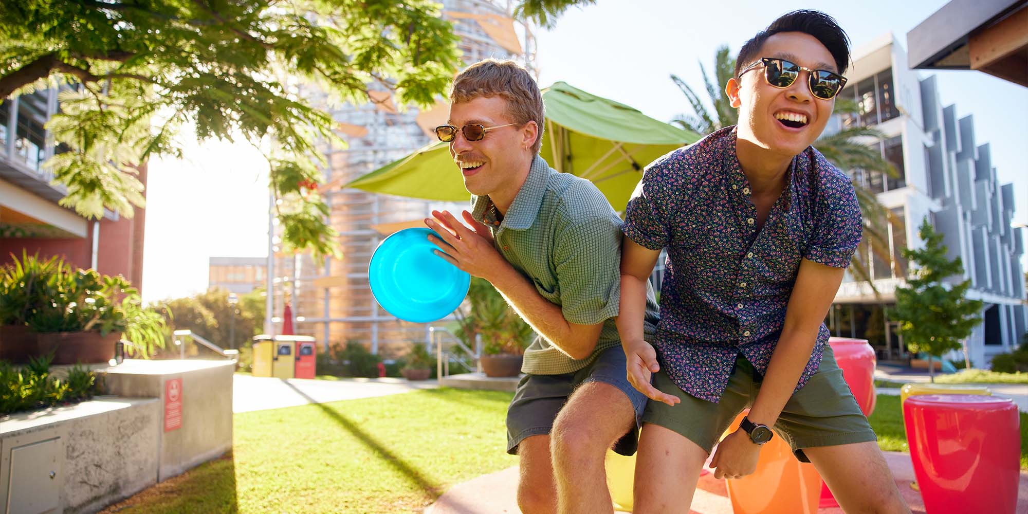 Two students playing frisbee