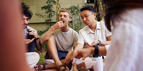student eating at a picnic